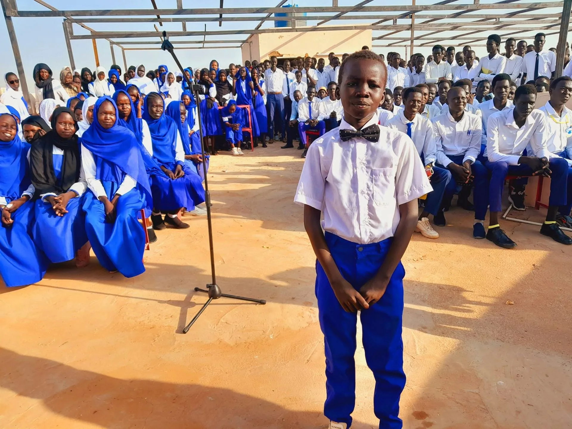 Bijany Matiok Deng Nyai standing before his classmates